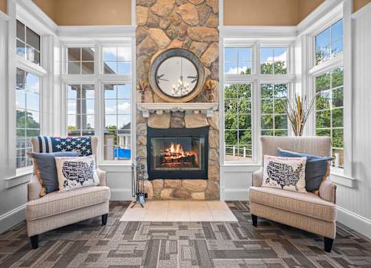 A cozy living room with a fireplace and two couchesk at Timberlane Apartments, Peoria, Illinois