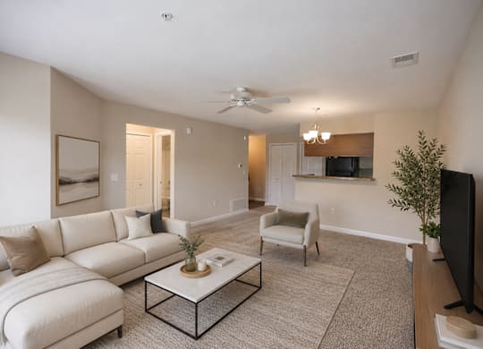 A living room with a white couch and a coffee table.