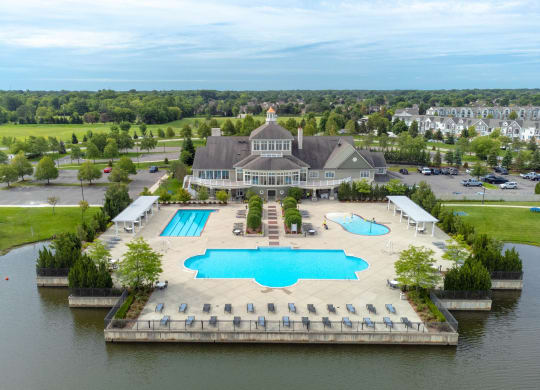 an aerial view of a large pool with a building in the backgroundat The Harbours Apartments, Michigan, 48038