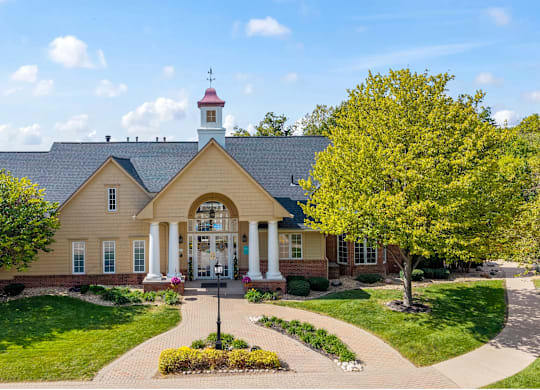 A house with a red roof and a white columned porch at Timberlane Apartments, Illinois, 61615