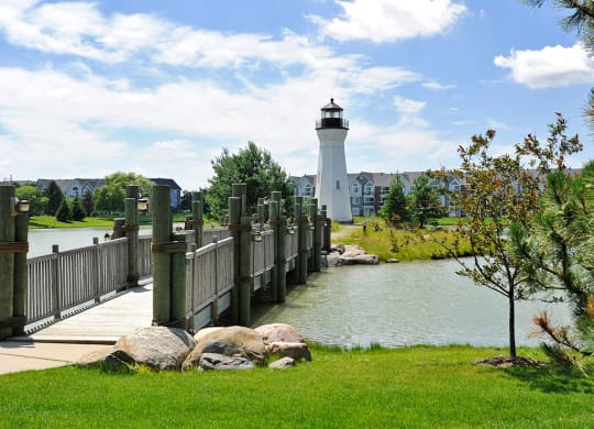 Community Lake with Crossing Bridge and Lighthouse at The Harbours Apartments, Clinton Twp, 48038