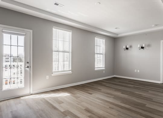 an empty living room with a door and windows at Alexandria of Carmel Apartments, Carmel