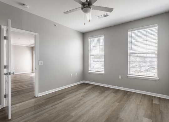 the living room of an empty house with a ceiling fan at Alexandria of Carmel Apartments, Carmel, 46032
