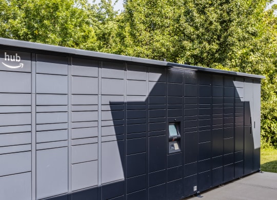 a shed with a door and a shadow on the side of it at Alexandria of Carmel Apartments, Carmel, 46032