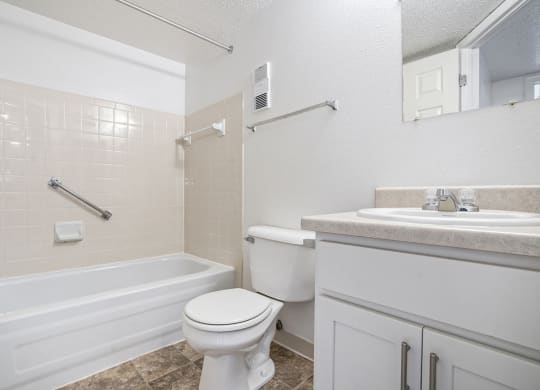 a bathroom with a sink toilet and a bath tub at Apple Ridge Apartments, Michigan, 49534