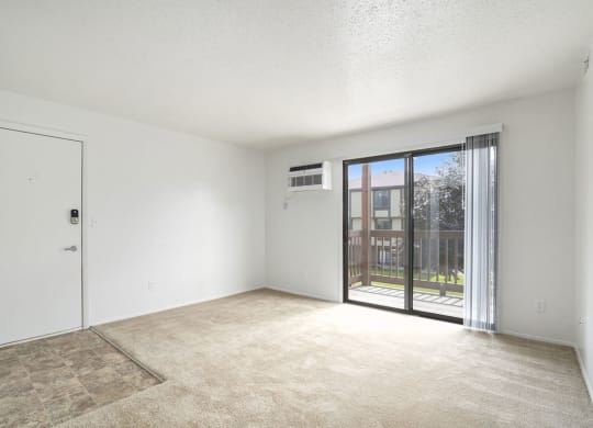 living room with a door to a balcony at Apple Ridge Apartments, Michigan, 49534