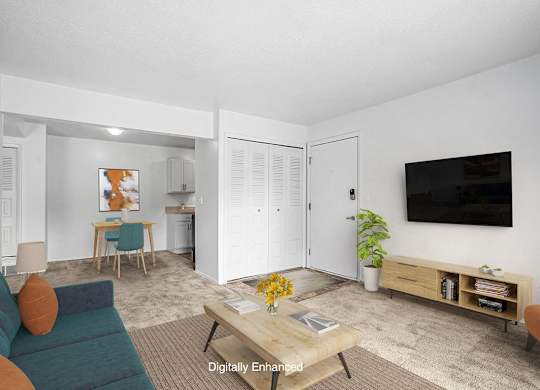 A living and dining room with plush carpeting  at Apple Ridge Apartments, Walker, MI