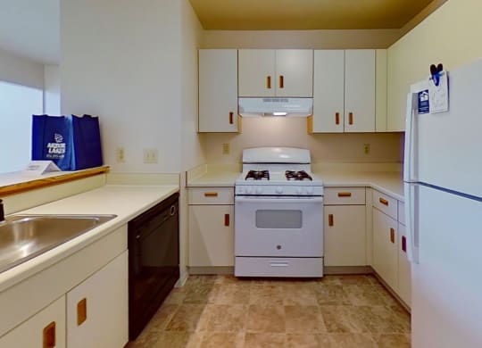 a kitchen with white appliances  at Arbor Lakes Apartments, Elkhart, 46516