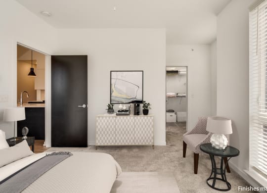 a bedroom with a bed sitting next to a window  at Uptown Square Apartments, Troy, MI