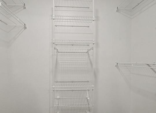 A walk-in closet with wardrobe organizers at Autumn Lakes Apartments and Townhomes, Mishawaka, 46544