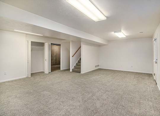 A spacious room with a staircase and a window at Autumn Lakes Apartments and Townhomes, Mishawaka, 46544