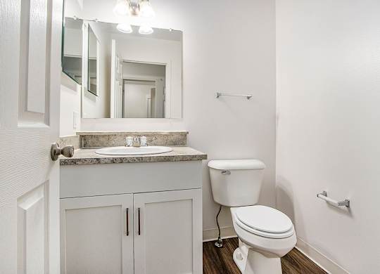 A white toilet sits next to a sink in a bathroom at Autumn Lakes Apartments and Townhomes, Mishawaka, 46544