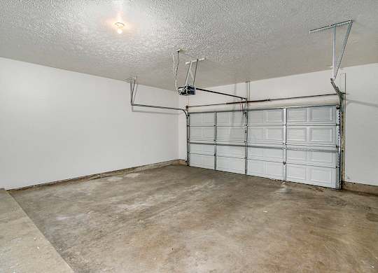 A garage with a white wall and a white door at Autumn Lakes Apartments and Townhomes, Mishawaka, 46544