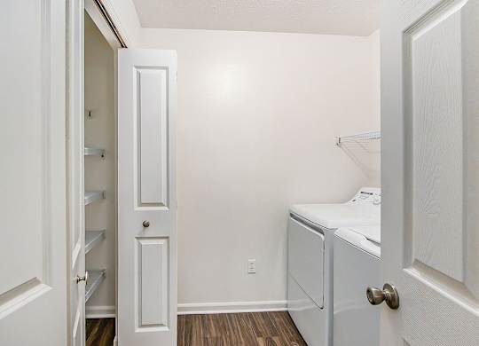 A small white laundry room with a washer and dryer at Autumn Lakes Apartments and Townhomes, Mishawaka, 46544