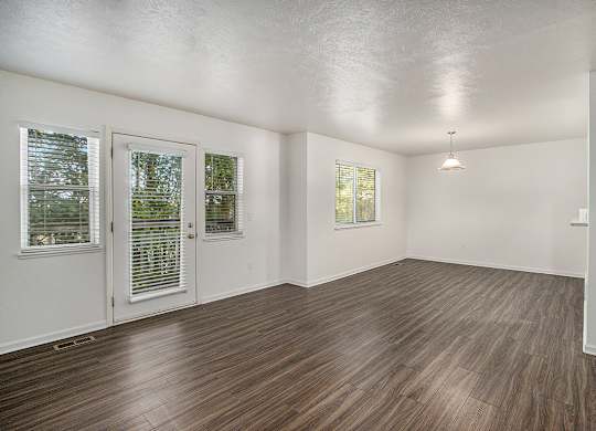 A living and dining room with vinyl plank flooring and white walls at Autumn Lakes Apartments and Townhomes, Mishawaka, 46544