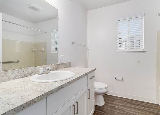 A white bathroom with a sink, toilet, and bathtub at Autumn Lakes Apartments and Townhomes, Mishawaka, 46544
