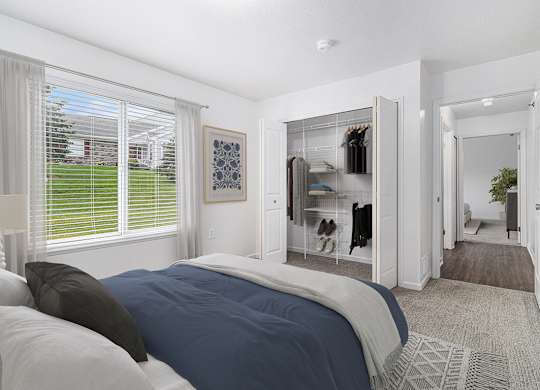 A bedroom with a large bed and a walk-in closet at Autumn Lakes Apartments and Townhomes, Mishawaka, 46544