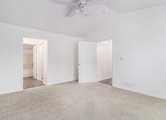 A bedroom with a high ceiling, ceiling fan and carpeted floor at Autumn Lakes Apartments and Townhomes, Mishawaka, 46544