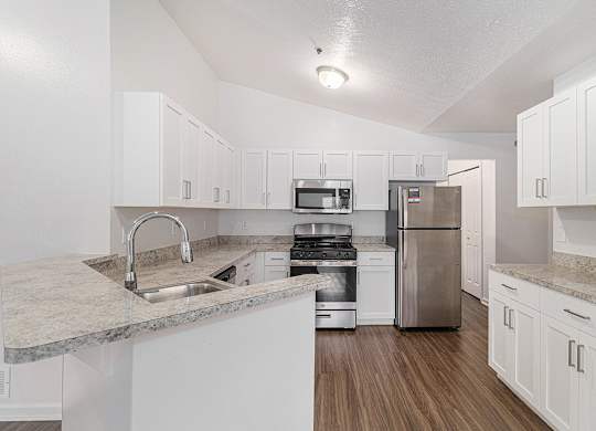 A kitchen with white shaker-style  cabinets and stainless steel appliances at Autumn Lakes Apartments and Townhomes, Mishawaka, 46544