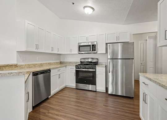 A kitchen with white shaker cabinets and stainless steel appliances at Autumn Lakes Apartments and Townhomes, Mishawaka, 46544