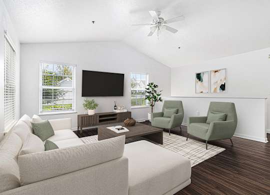 A living room with a couch, a coffee table, and a vaulted ceiling with ceiling fan at Autumn Lakes Apartments and Townhomes, Mishawaka, 46544