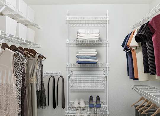 a walk in closet with wardrobe organizers at Autumn Lakes Apartments and Townhomes, Indiana, 46544