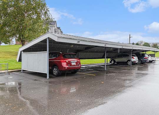 A carport bay with cars parked in it at Autumn Lakes Apartments and Townhomes, Mishawaka, IN