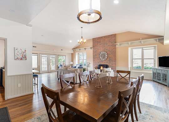A clubhouse dining room with a wooden table and chairs at Autumn Lakes Apartments and Townhomes, Mishawaka, IN