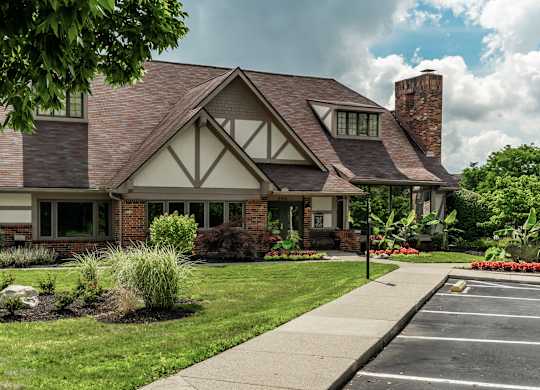 A house with a brick chimney and a large front yard