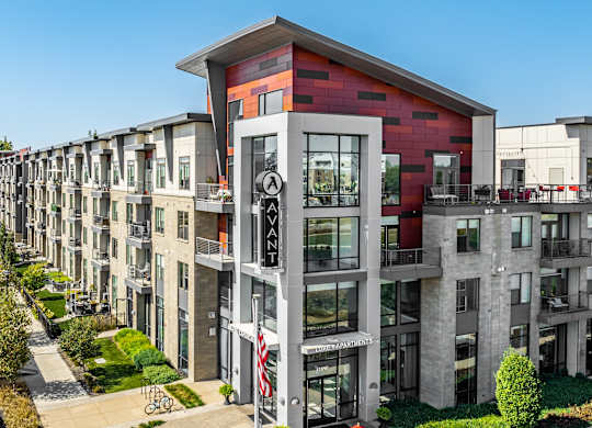 an aerial view of a large apartment building with red and white facade at Avant & Avant II, Carmel, IN, 46032