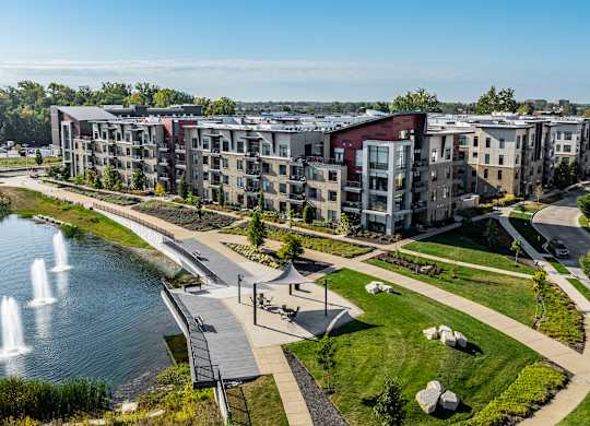 an aerial view of an apartment complex with a lake and fountain at Avant & Avant II, Carmel, IN, 46032