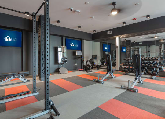 a fitness room with weights and exercise equipment at Avant Apartments in Carmel, 46032