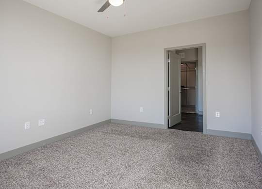 an empty living room with carpeting and a door to a hallway at Avant & Avant II, Carmel, IN, 46032