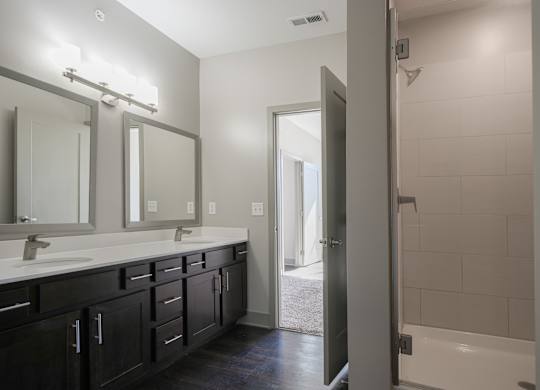 an empty bathroom with two sinks and a shower at Avant & Avant II, Carmel, IN, 46032