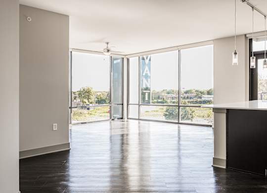 a living room with glass doors and a view of a city at Avant & Avant II, Carmel, IN, 46032