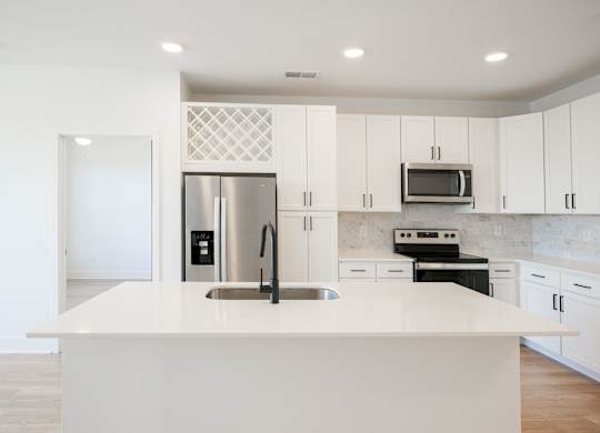 a large white kitchen with stainless steel appliances and white cabinets at Avant & Avant II, Carmel, IN, 46032