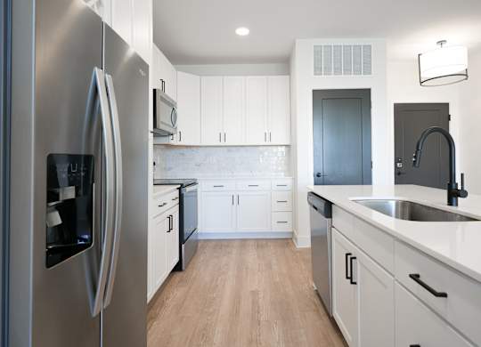 a kitchen with white cabinets and stainless steel appliances at Avant & Avant II, Carmel, IN, 46032