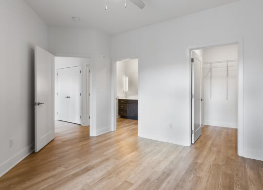 an empty living room with white walls and wood floors in Carmel, IN
