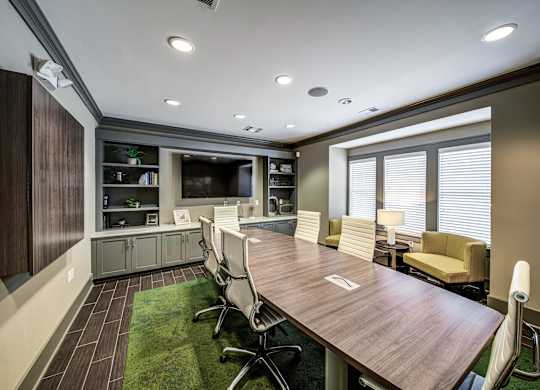 a conference room with a table and chairs and a television at Avellan Springs Apartments, Morrisville, North Carolina