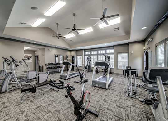 a gym with treadmills and other exercise equipment at the enclave at university crossings at Avellan Springs Apartments, Morrisville, North Carolina