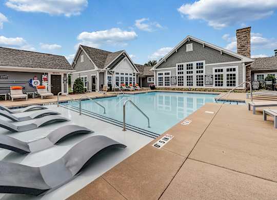 pool and building with lounge chairs at Avellan Springs Apartments, Morrisville, NC