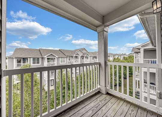 the view from the deck of a home with a balcony at Avellan Springs Apartments, Morrisville, North Carolina