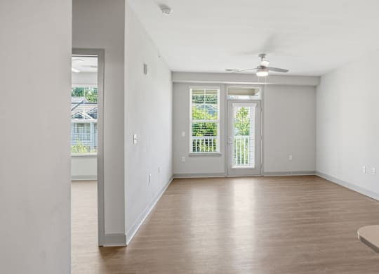 A room with a sliding glass door leading to a balcony.