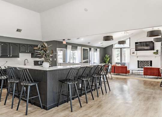 A modern kitchen with a bar area and a fireplace