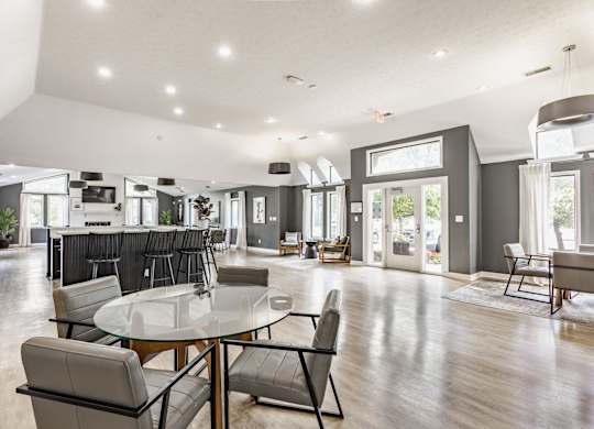 A modern dining room with a glass table and chairs