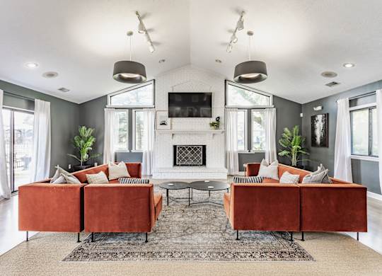 A living room with a fireplace and a television.
