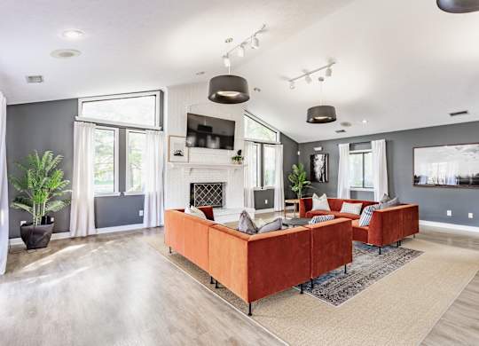 A modern living room with a fireplace and a large couch