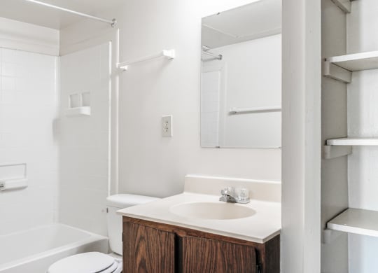 a bathroom with a sink and a shower and a toilet at Bavarian Village Apartments, Indianapolis, IN