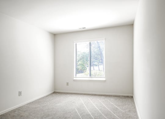 a room with white walls and a window at Bavarian Village Apartments, Indianapolis, IN