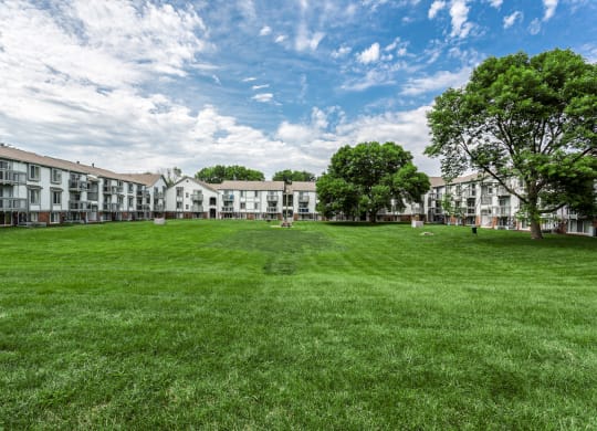 a large green lawn in front of a row of apartment buildings at Bay Pointe Apartments in Lafayette, IN 47909